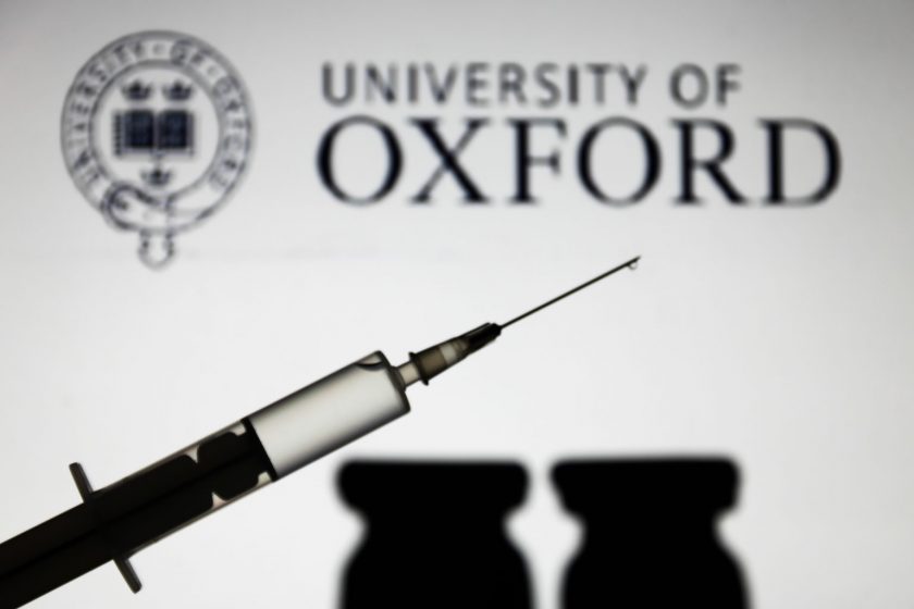 Medical syringe is seen with University of Oxford logo displayed on a screen in the background in this illustration photo taken in Poland on November 16, 2020. (Photo by Jakub Porzycki/NurPhoto via Getty Images)